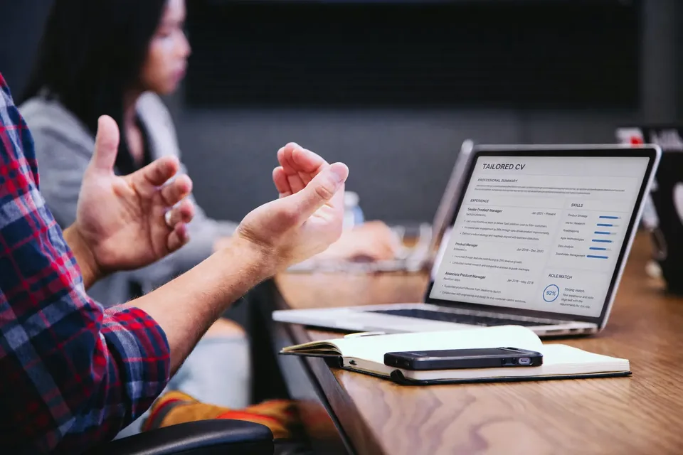 A vacancy-tailored CV being reviewed during a professional meeting